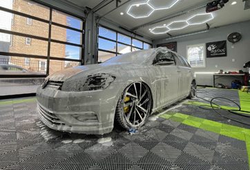 Flow through floor tile in a car detailing shop